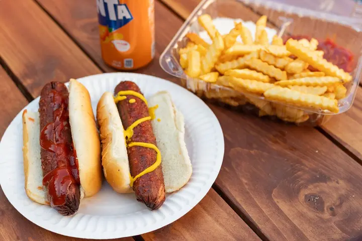 Hot dog meal with fries and a drink