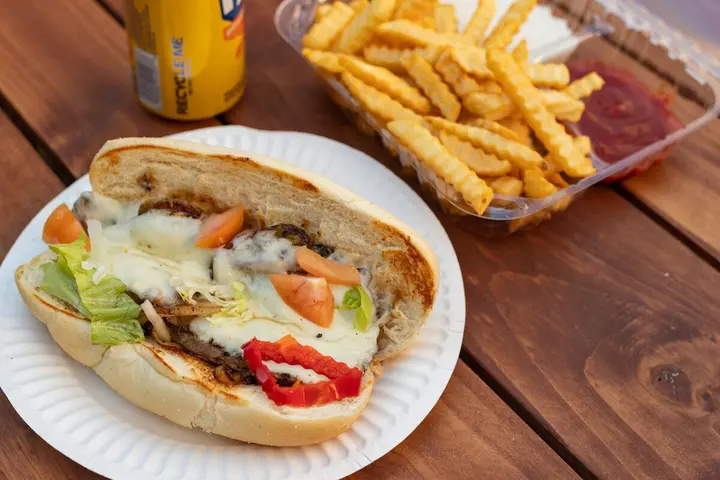 Philly cheese steak meal with fries and a drink